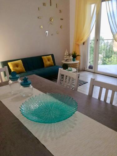 a living room with a glass plate on a table at Finestra sul mare in Monfalcone