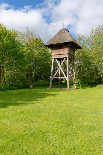 a gazebo in the middle of a grass field at Lehrerwohnung in Tümlauer Koog