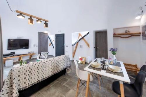 a living room with a table and a dining room at Aurum in Kamari