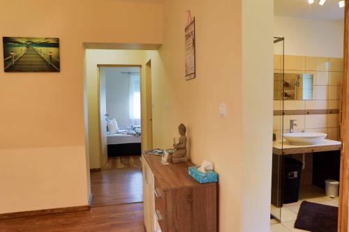 a bathroom with a figurine sitting on top of a counter at Villa Eszter in Balatonkeresztúr