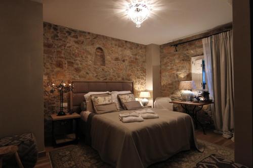 a bedroom with a bed with two towels on it at Boutique Hotel Casa Granados in Tossa de Mar