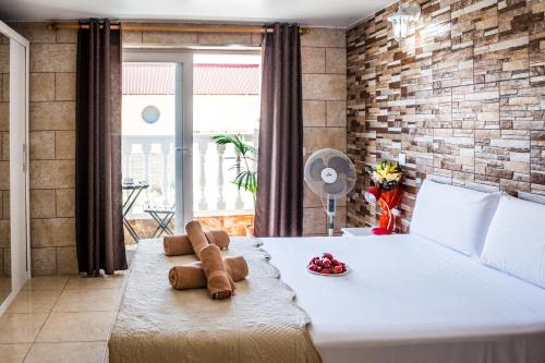 a bedroom with a bed with a teddy bear on it at Hostel Poseidon - HM in El Tablero