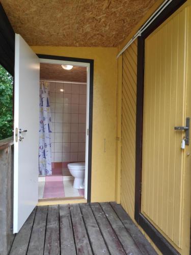 an open door to a bathroom with a toilet at White House puhkemaja in Uulu