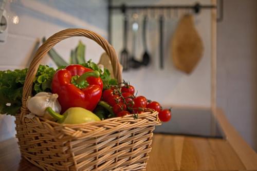a basket of vegetables sitting on a table at House Arupium - HOT TUB in Otočac