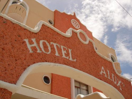 a red building with the word hotel on it at Hotel Alux Cancun in Cancún
