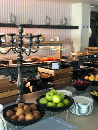 a kitchen with bowls of food on a table at Litohoro Olympus Resort Villas & Spa in Plaka Litochorou