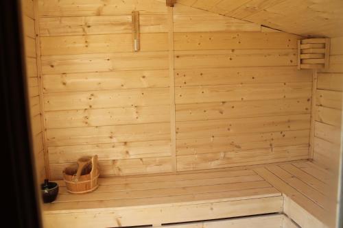 a wooden sauna with two pairs of shoes in it at B&B Artistic House in Cassano Magnago