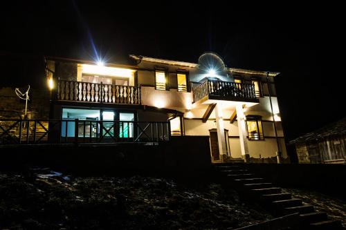a house at night with its lights on at Guest House Panorama in Gela