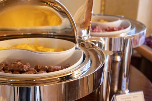 two trays of food on a buffet table at Albergo Le Due Corti in Como