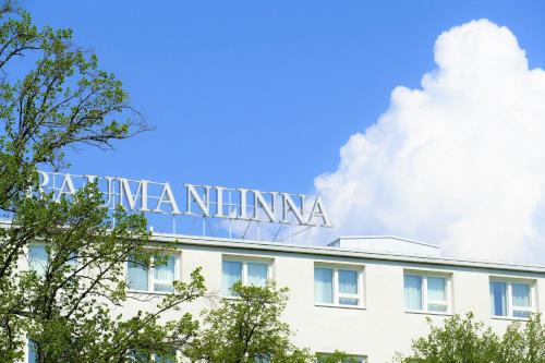 a sign on the top of a building with trees at Hotel Raumanlinna in Rauma