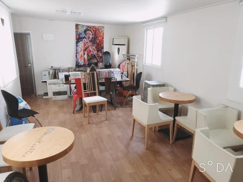 a room with tables and chairs in a room at Haru The Guesthouse in Andong