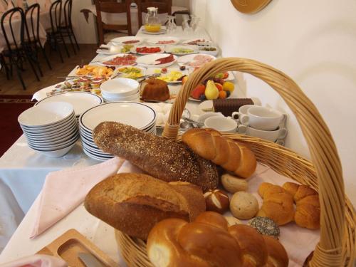 a table topped with a basket of bread and pastries at Hotel Al Fiume in Tegna