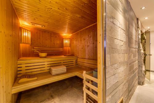 a sauna in a wooden building with a wall at Chalet Hotel Du Fornet in Val dʼIsère