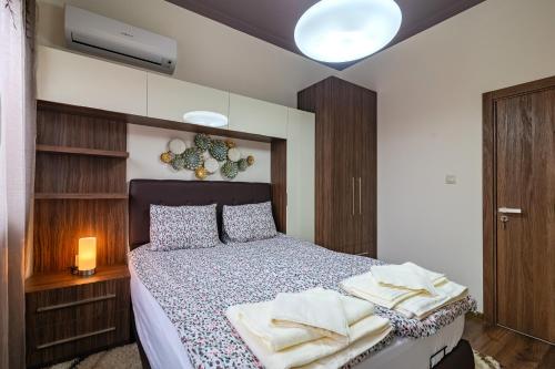 a bedroom with a bed with towels on it at Cosy Luxury Flat in the Centrum- 90sqm - 3 rooms. in Varna City