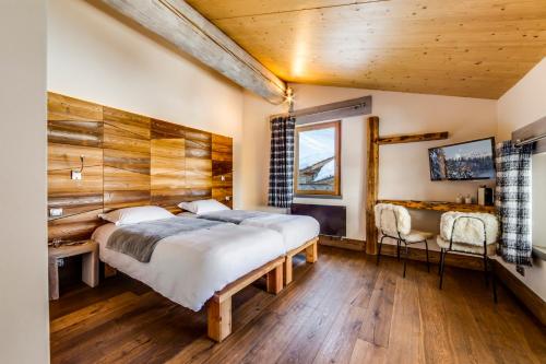 Postel nebo postele na pokoji v ubytování Chalet Hotel Du Fornet
