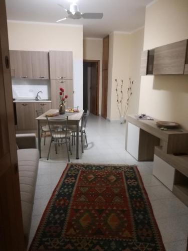 a living room and kitchen with a table and chairs at Giusy's Place 1 in Campofelice di Roccella