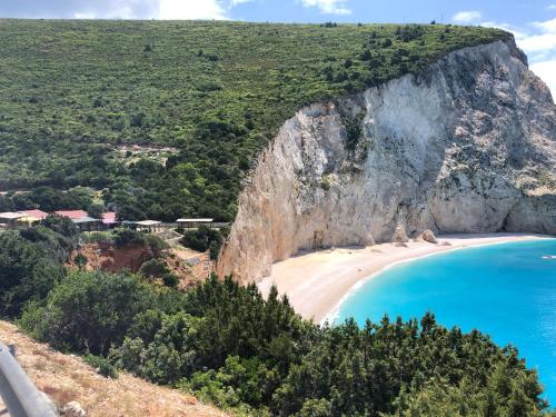 a view of a beach with a large cliff at Sivros Stone Cottages in Sívros
