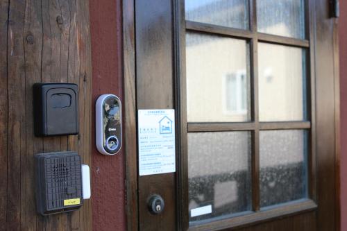a door with a sign on it next to a window at Sapporo Luxury Log House 5Brm max 18ppl 4 free parking in Sapporo