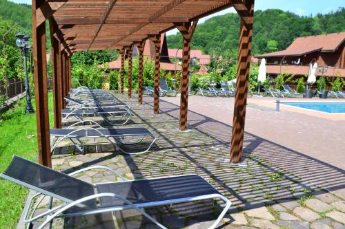 a row of chairs under a pavilion next to a pool at Belle Royalle in Lisarnya