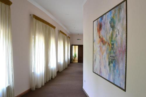 a hallway with a large painting on the wall at Belle Royalle in Lisarnya