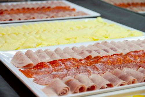 a display of different types of meats and cheese at Wellness Hotel Montis in Mozirje