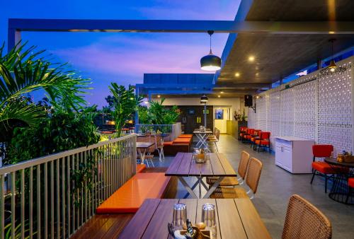 a restaurant with tables and chairs on a balcony at Southern Star,Bangalore in Bengaluru