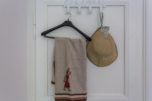 a towel and a hat are hanging on a door at Studio Elly in Dubrovnik