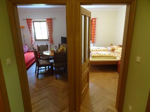 a room with a dining table and a room with a bed at Apartmány Pod Javorem in Pec pod Sněžkou
