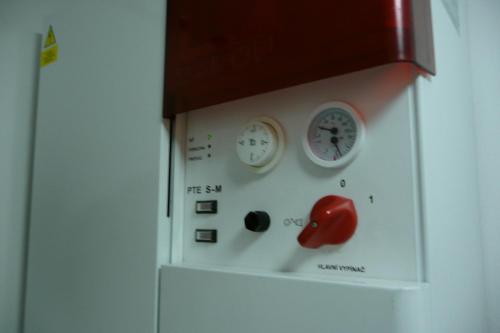 a clock with a red apple on a wall at Apartmány Pod Javorem in Pec pod Sněžkou