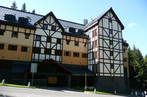 a large building with black and white at Apartmány Pod Javorem in Pec pod Sněžkou