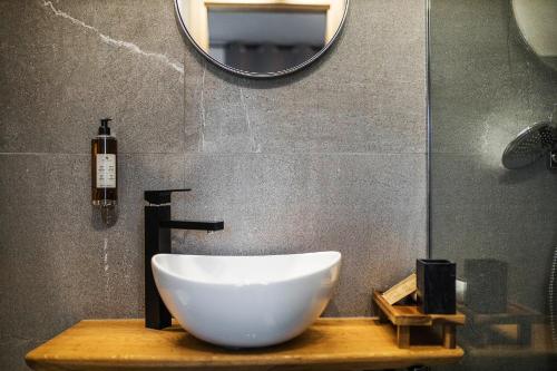 a bathroom with a bowl sink and a mirror at Hotel Pok Garni in Brezovica
