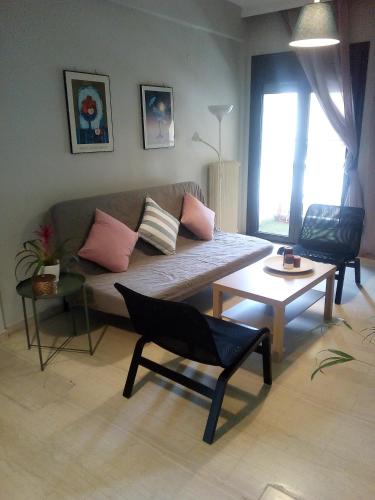 a living room with a couch and a table at Karditsa Home Sweet Home 80 τ.μ in Kardítsa