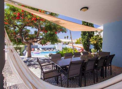 a dining room with a table and chairs and a pool at Horta's villa - private heatable Pool in Lagos