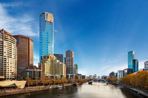a view of a city with a river and buildings at Flinders Landing Apartments in Melbourne