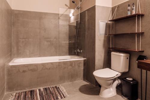 a bathroom with a shower and a toilet and a tub at Sunny Beach Club - Adults Only #YouthfulVibes in Sunny Beach