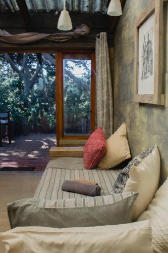 a living room with a couch and a window at The Prawn Hatchery Pty Ltd on Amatikulu in Dokodweni