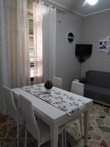 a white table and chairs in a living room at Aspra al delfino blu in Bagheria