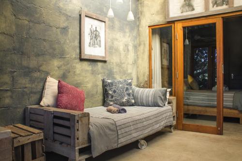 a room with a couch with a dog laying on it at The Prawn Hatchery Pty Ltd on Amatikulu in Dokodweni