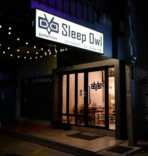 a sign for a sleep gym on the side of a building at Sleep Owl Hostel in Bangkok