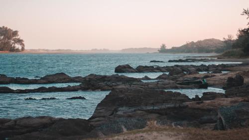a view of a body of water with rocks at The Prawn Hatchery Pty Ltd on Amatikulu in Dokodweni