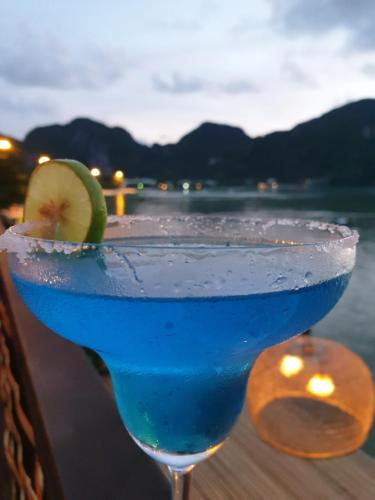 a blue drink with a lime on top of a table at Phi Phi Green House & Sunsky Hostel in Phi Phi Don