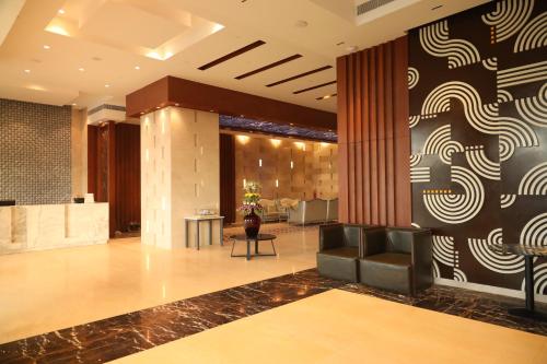 a lobby of a hotel with chairs and a wall at Regenta Central RS Chennai OMR SIPCOT in Chennai