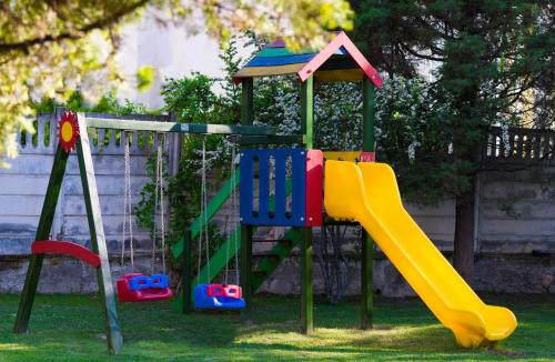 a playground with a colorful slide and a swing at Herakles Thermal Hotel in Pamukkale