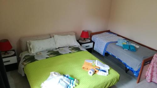 a bedroom with two beds with toy trucks on the bed at B&b Etneo in Belpasso