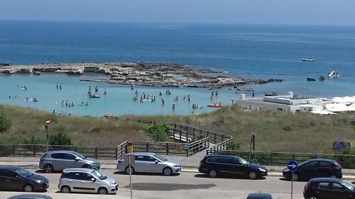a group of people in the water at a beach at Bilocale Punta Rosa - Fronte Spiaggia in Otranto