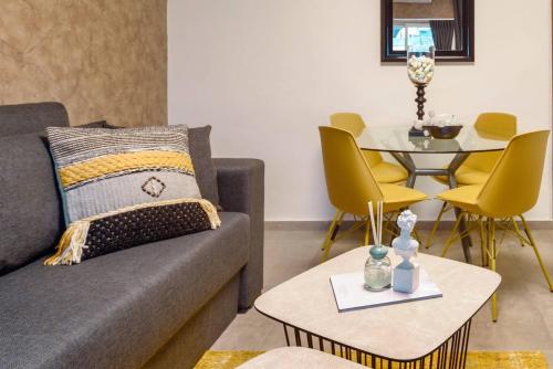 a living room with a couch and a table at Havatselet 19 By Isrentals in Jerusalem