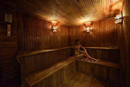 a woman is sitting in a sauna at Herakles Thermal Hotel in Pamukkale