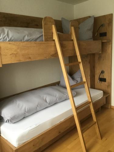 two bunk beds in a room with a ladder at Landgasthof Kinzigstrand in Biberach bei Offenburg