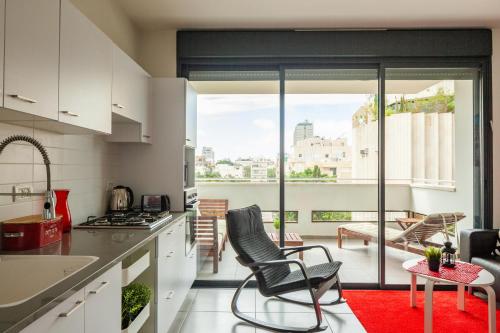 a kitchen with two chairs and a table in a room at Sunny Luxury Apartments in Tel Aviv