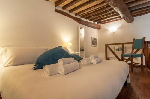 a bedroom with a large white bed with towels on it at Umbrian Concierge - Cozy Loft Vannucci in Perugia